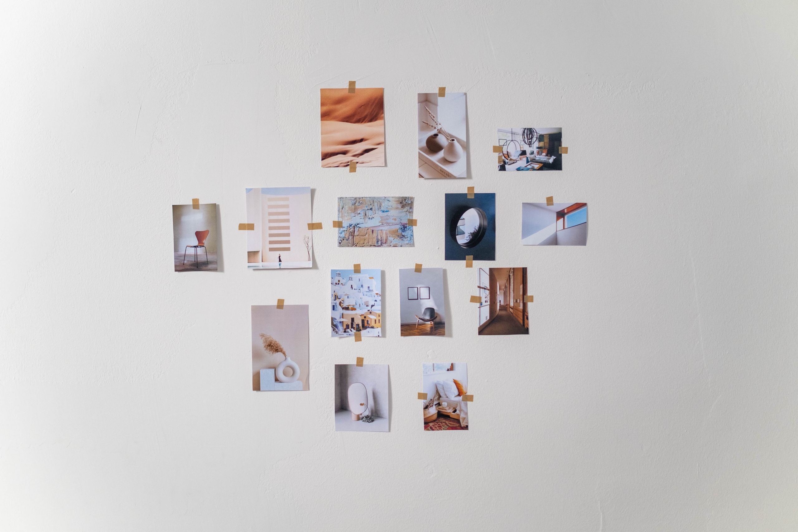 Aesthetic arrangement of photos on a white wall in a minimalist style.